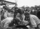 32. F2/10.34. Jean M Fangio No2 (ARG) Maseratti 250F, exiting car in pits, British GP, Aintree 1957.