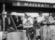 6. F2/2.17. Jean Fangio's long time lover cleans his goggles on pit wall, British GP Aintree 1957.